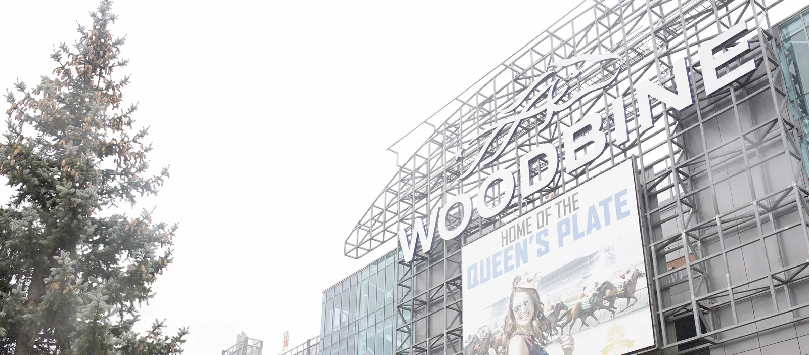 Glass and steel exterior of the Woodbine Racetrack complex where the on-site hotel is located