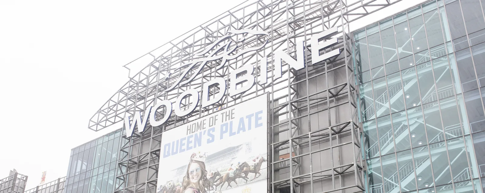 Glass and steel exterior of the Woodbine Racetrack complex near the on-site hotel